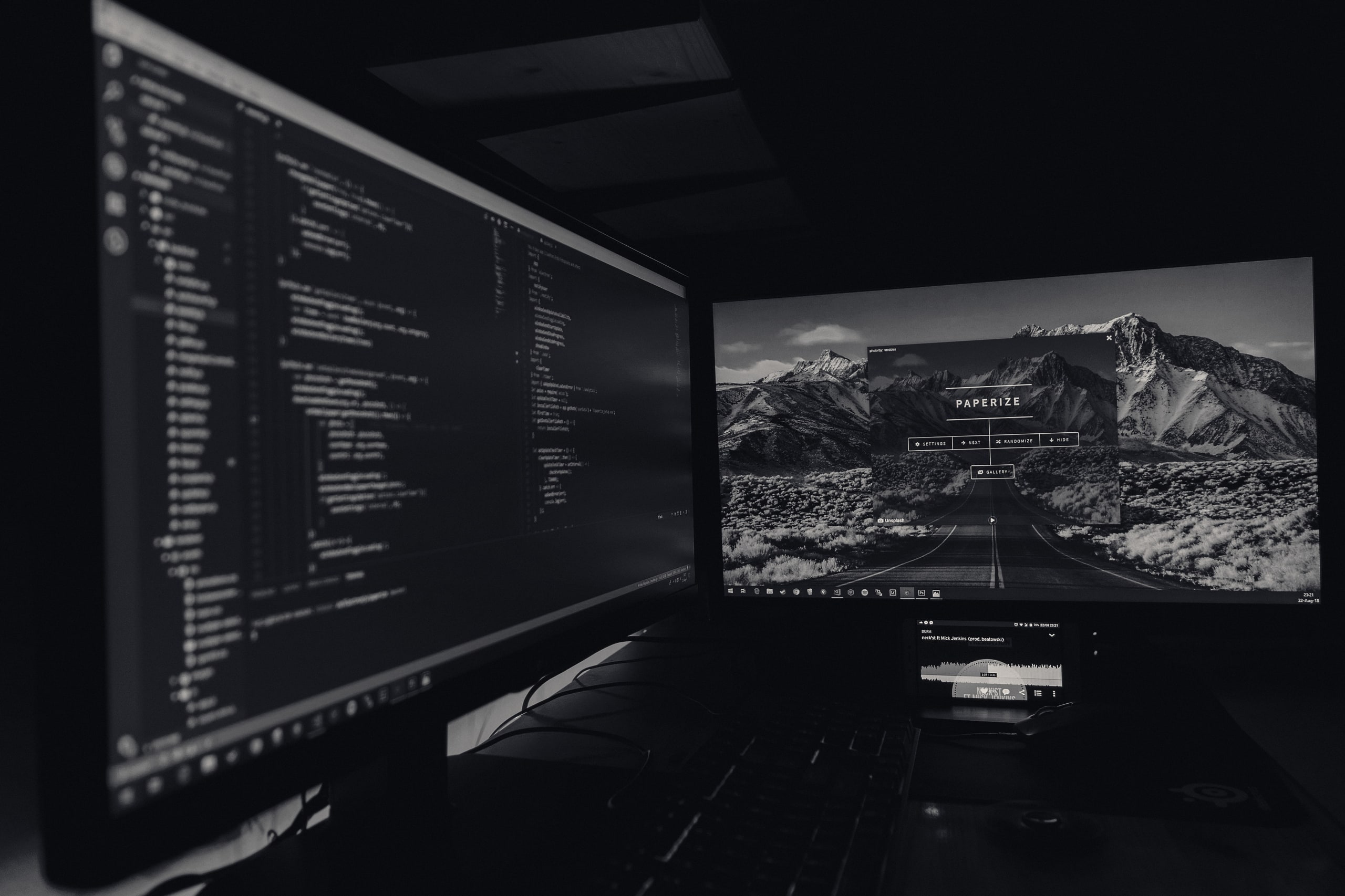 Dark monitors showing code in a quiet office