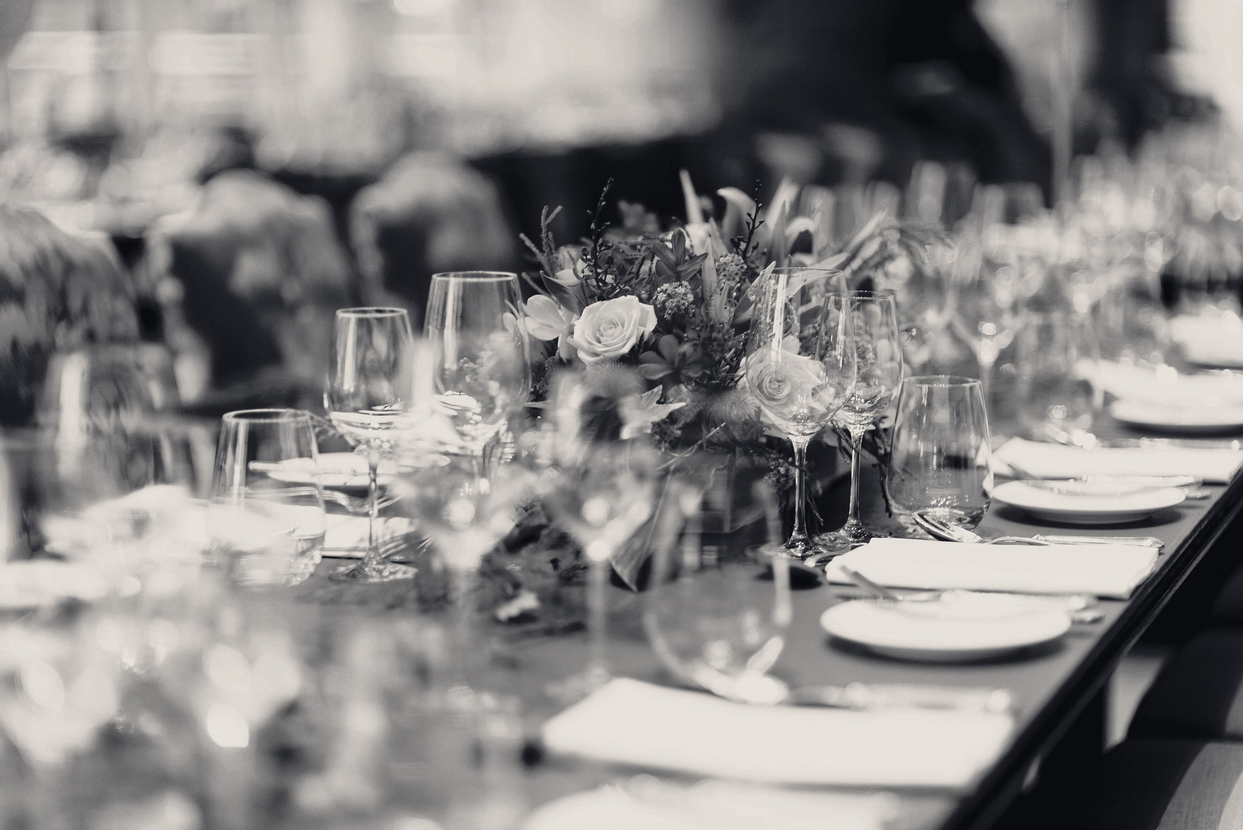 Long event table set with glasses and flowers