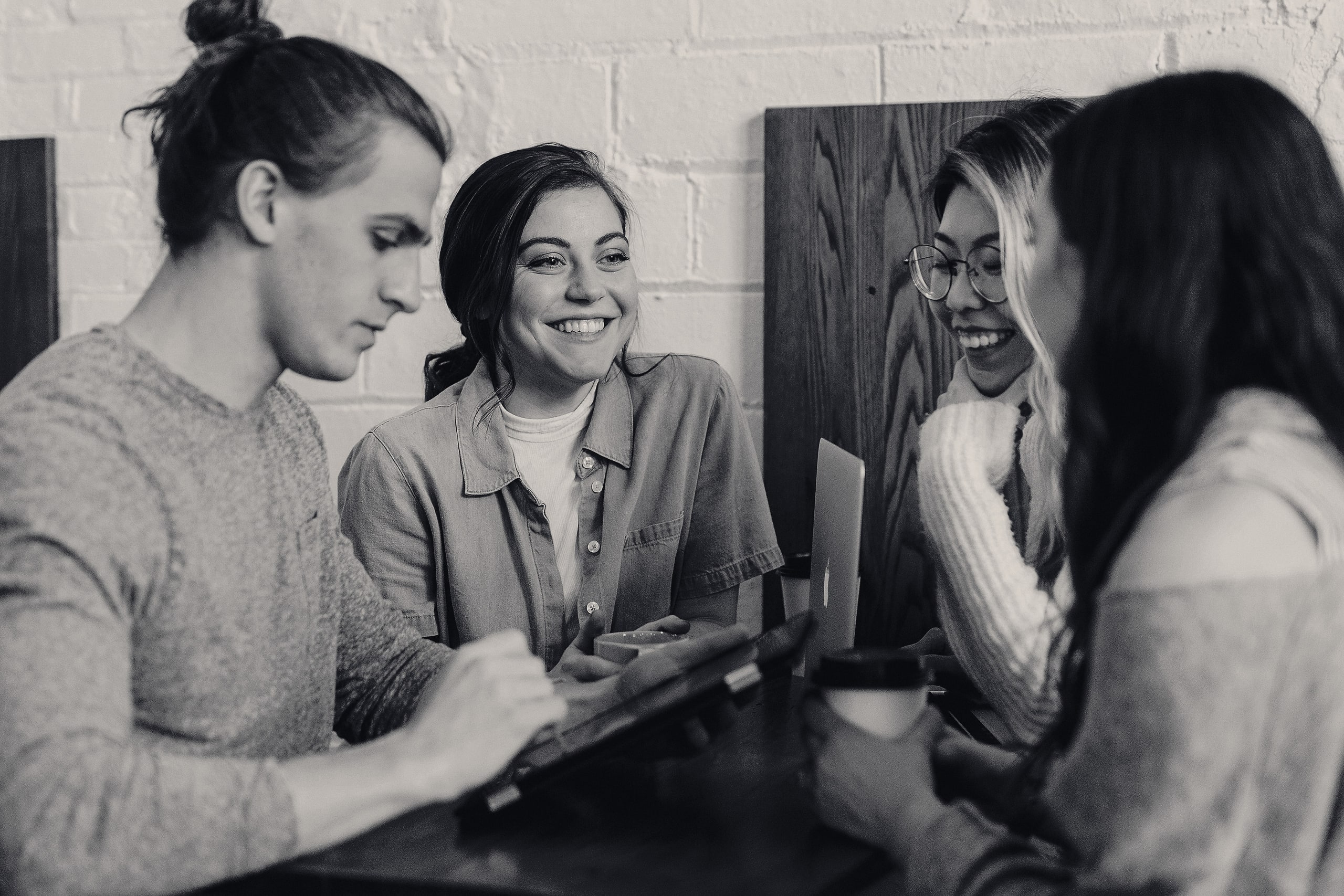 Colleagues collaborating around a table with tablets and coffee