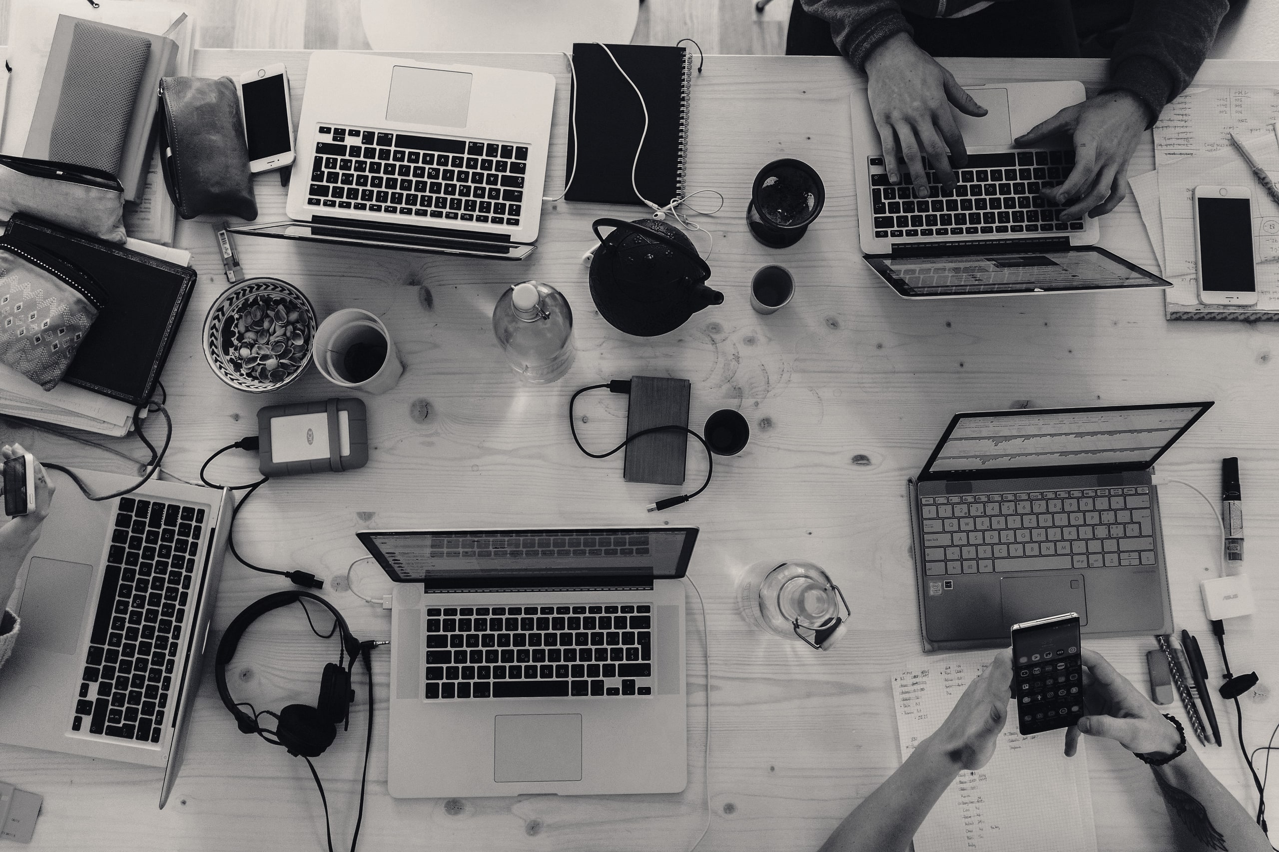Overhead view of a team working with laptops around a shared table