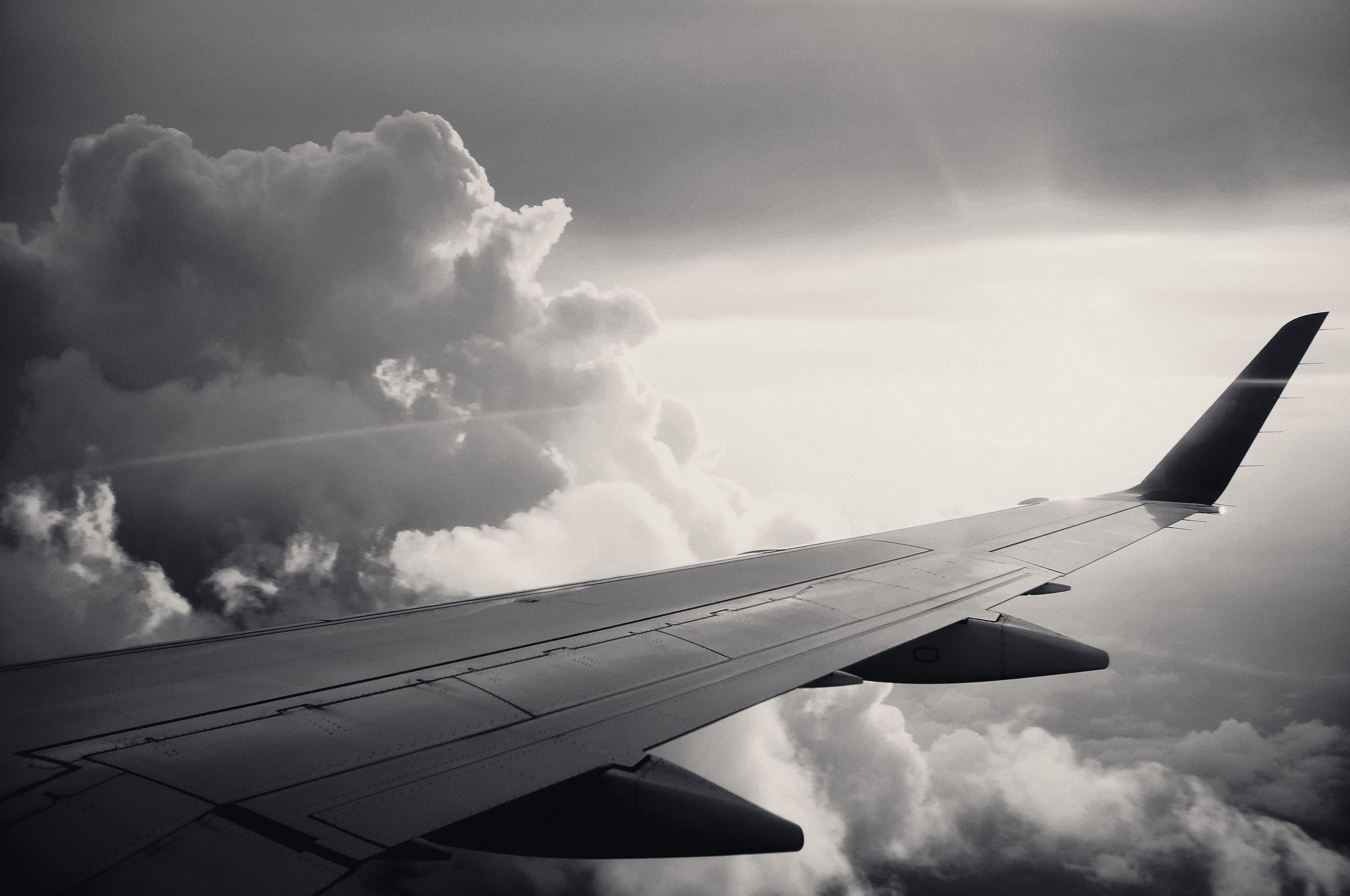 Aircraft wing above clouds at sunrise